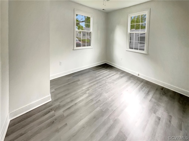 spare room with dark hardwood / wood-style floors