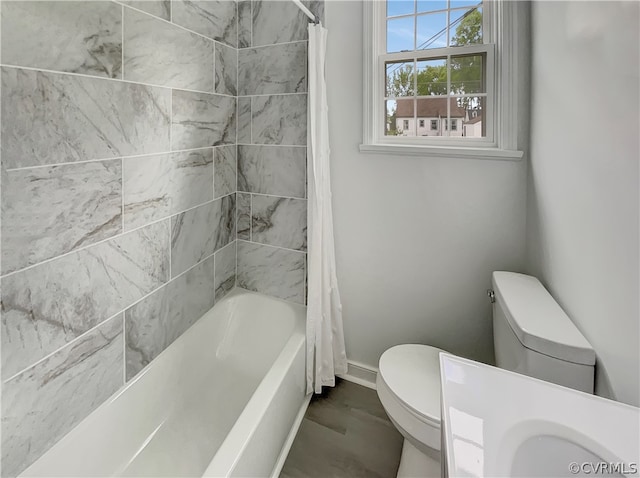 bathroom with toilet, tile flooring, and shower / tub combo with curtain