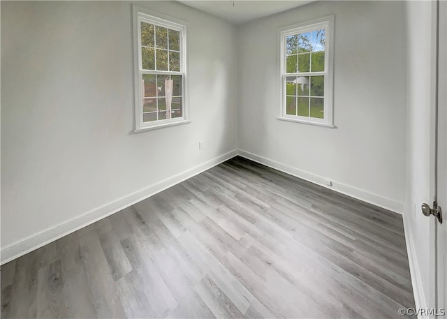 spare room with wood-type flooring