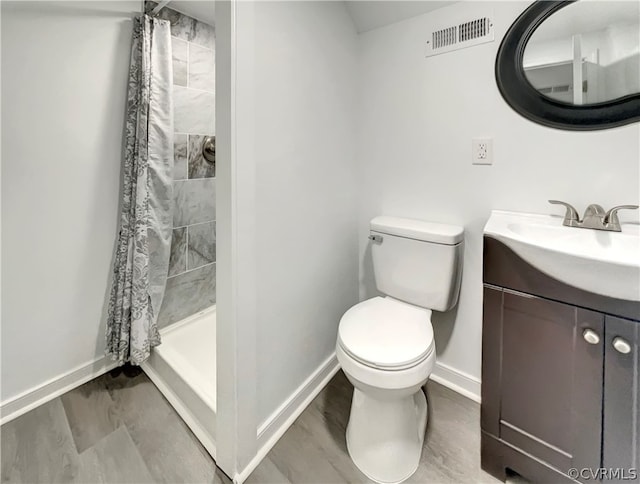 bathroom featuring a shower with shower curtain, vanity, toilet, and hardwood / wood-style flooring