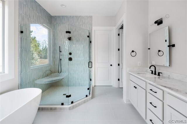 bathroom featuring tile floors, plus walk in shower, and vanity