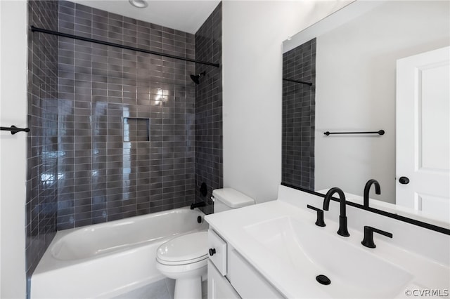 full bathroom with tiled shower / bath, tile flooring, oversized vanity, and toilet