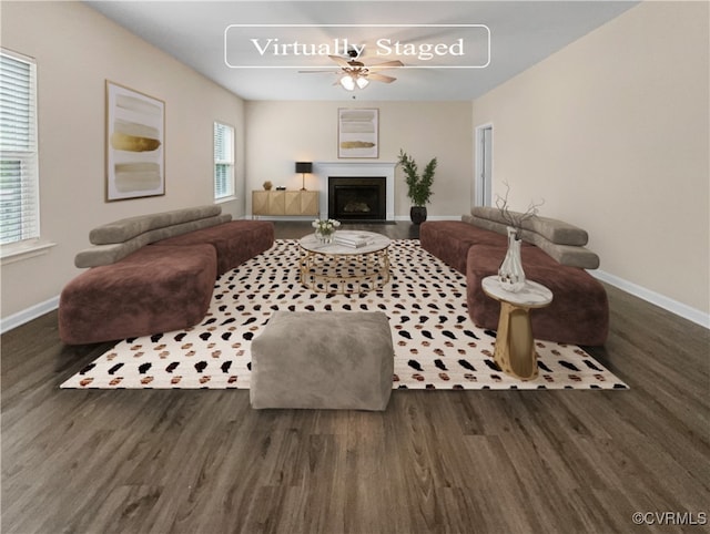 living room with ceiling fan, plenty of natural light, and dark wood-type flooring