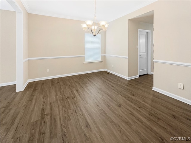 unfurnished dining area featuring an inviting chandelier, crown molding, and dark hardwood / wood-style flooring