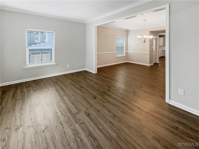 unfurnished room featuring an inviting chandelier, ornamental molding, and dark hardwood / wood-style floors