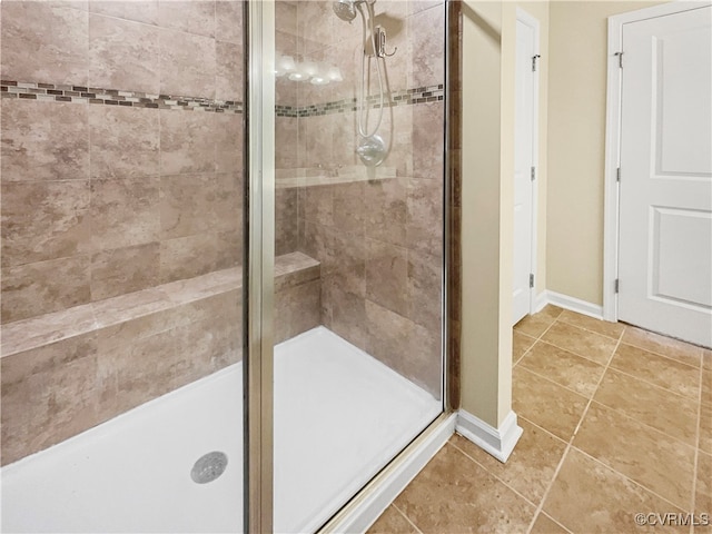 bathroom with tile patterned flooring and a shower with door