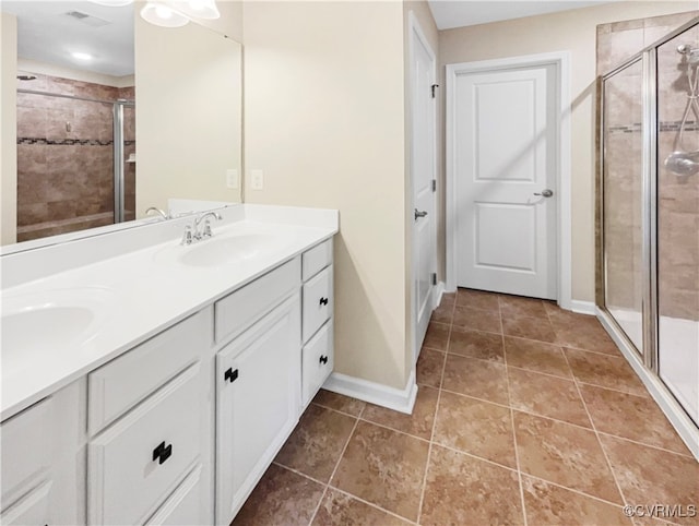 bathroom featuring tile patterned floors, an enclosed shower, and vanity