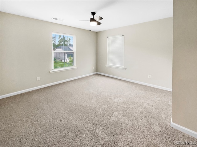 carpeted empty room featuring ceiling fan