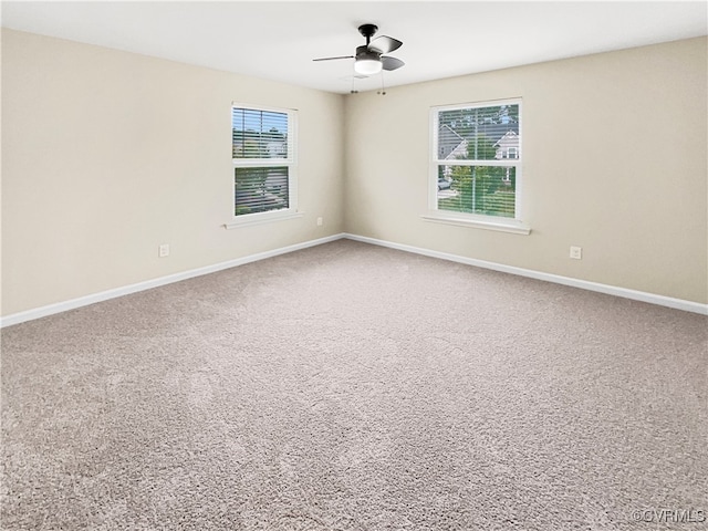 empty room featuring carpet floors, plenty of natural light, and ceiling fan