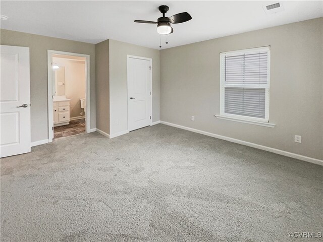 unfurnished bedroom with carpet, connected bathroom, and ceiling fan