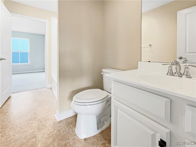 bathroom featuring tile patterned flooring, vanity, and toilet