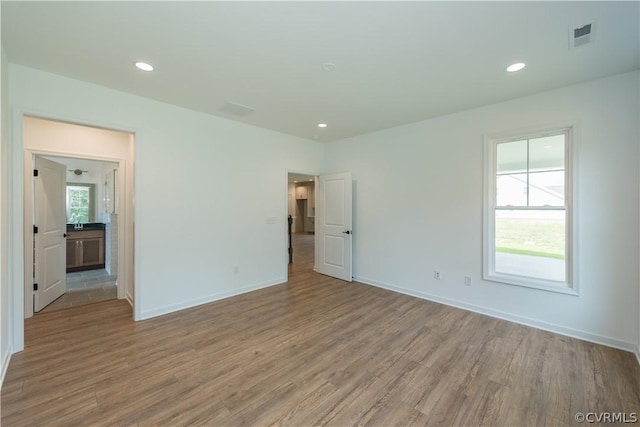 spare room with light wood-type flooring