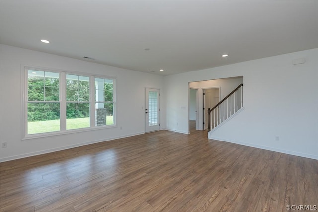 unfurnished living room featuring hardwood / wood-style flooring