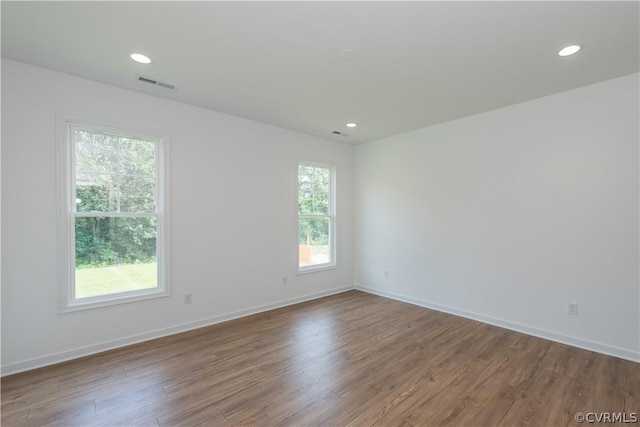 unfurnished room with plenty of natural light and hardwood / wood-style flooring