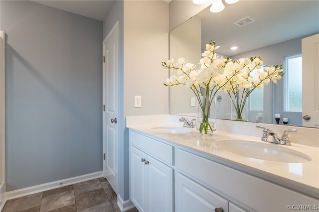 bathroom featuring tile patterned floors and dual bowl vanity