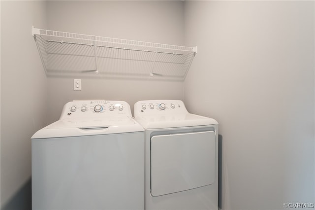 washroom with washing machine and clothes dryer