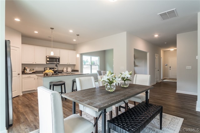 dining area with dark hardwood / wood-style floors