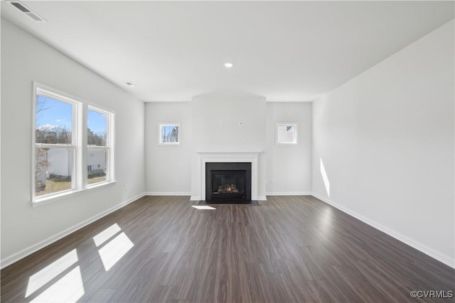 229 Bellevue Cir, King William, VA 23009 - unfurnished living room featuring plenty of natural light, a fireplace with flush hearth, baseboards, dark wood-type flooring, and recessed lighting