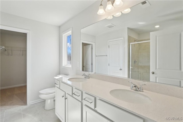229 Bellevue Cir, King William, VA 23009 - full bathroom with a shower stall, double vanity, toilet, a walk in closet, and baseboards
