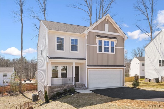233 Bellevue Cir, King William, VA 23009 - view of front of house with covered porch, asphalt driveway, a garage, and cooling unit