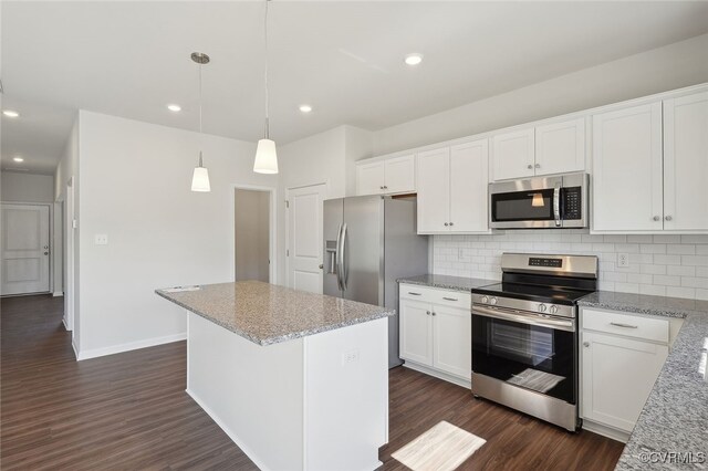233 Bellevue Cir, King William, VA 23009 - kitchen with appliances with stainless steel finishes, decorative backsplash, white cabinetry, a center island, and recessed lighting