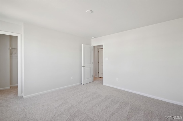 233 Bellevue Cir, King William, VA 23009 - unfurnished bedroom featuring light carpet, a spacious closet, baseboards, and a closet