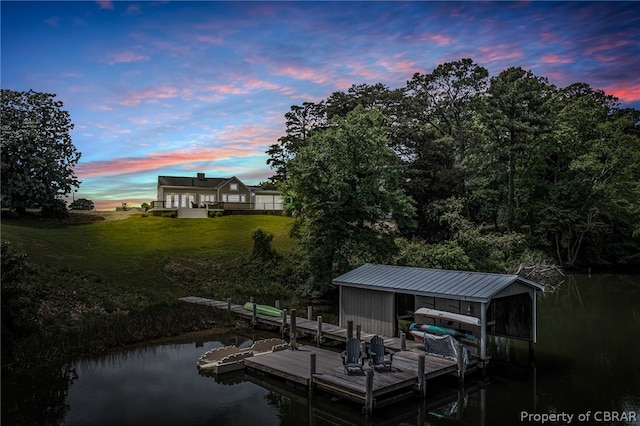 dock area with a water view and a lawn