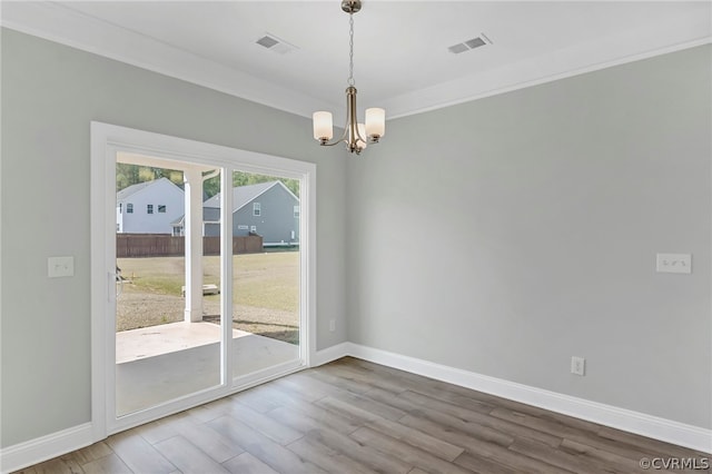 unfurnished room featuring ornamental molding, wood-type flooring, and plenty of natural light