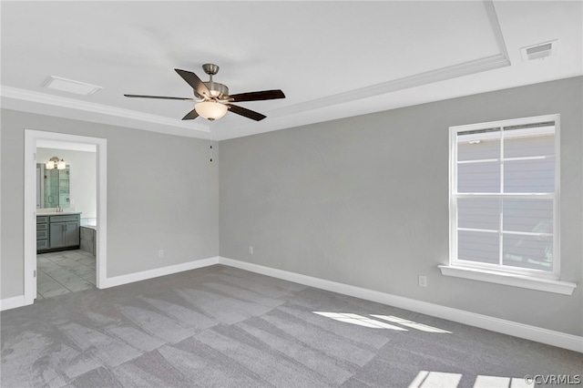 carpeted spare room with ceiling fan and ornamental molding