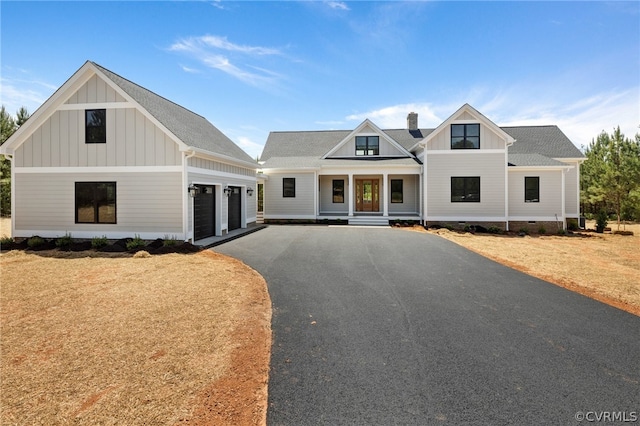 modern farmhouse style home with a garage and covered porch