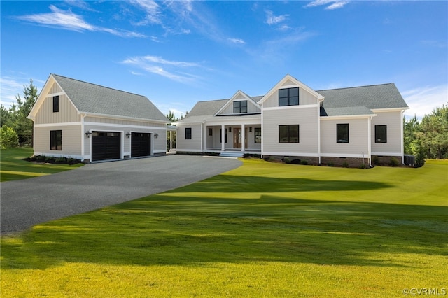 view of front of house with a front yard, a garage, and central AC unit