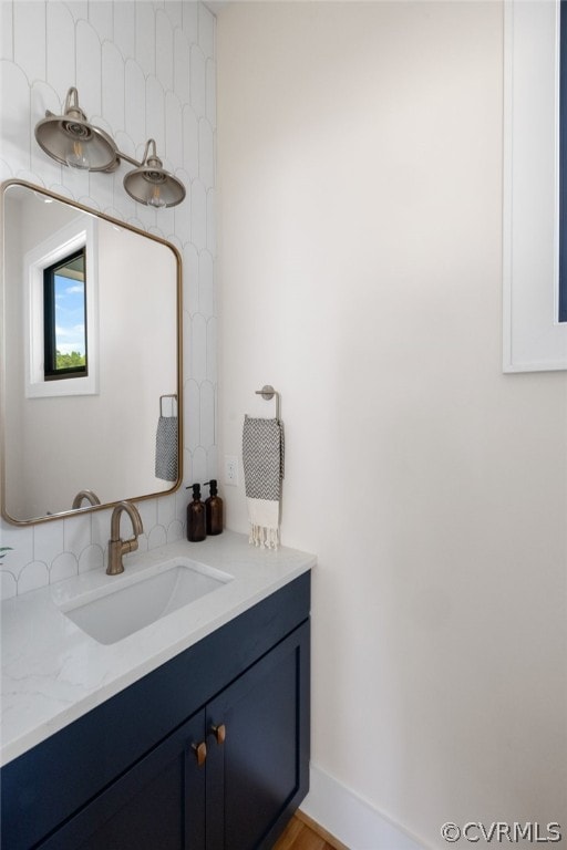 bathroom featuring oversized vanity and tasteful backsplash