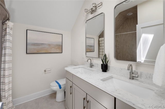 bathroom with tile floors, double sink, toilet, and vanity with extensive cabinet space