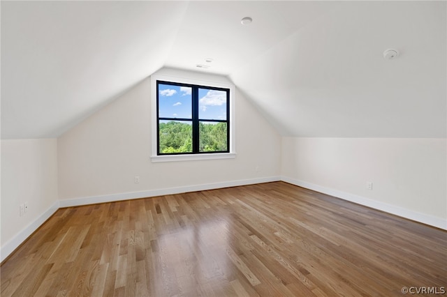 bonus room featuring hardwood / wood-style floors and lofted ceiling