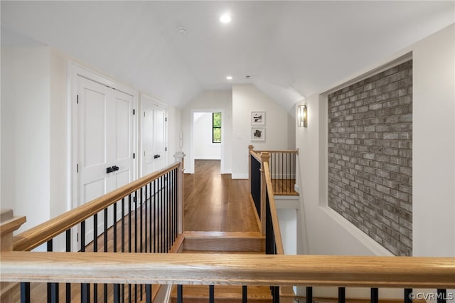 hall featuring dark hardwood / wood-style flooring and lofted ceiling