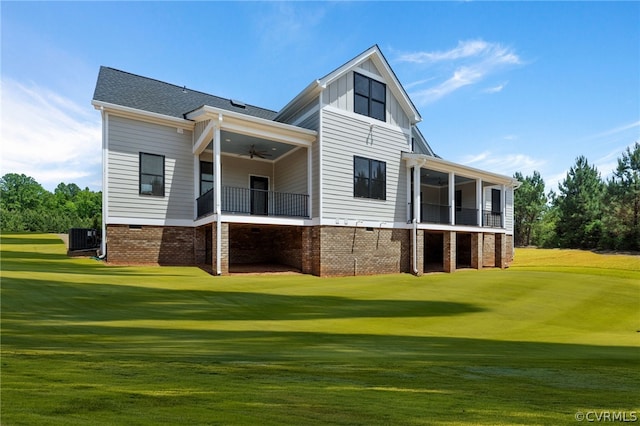 back of house featuring a balcony, ceiling fan, central air condition unit, and a lawn