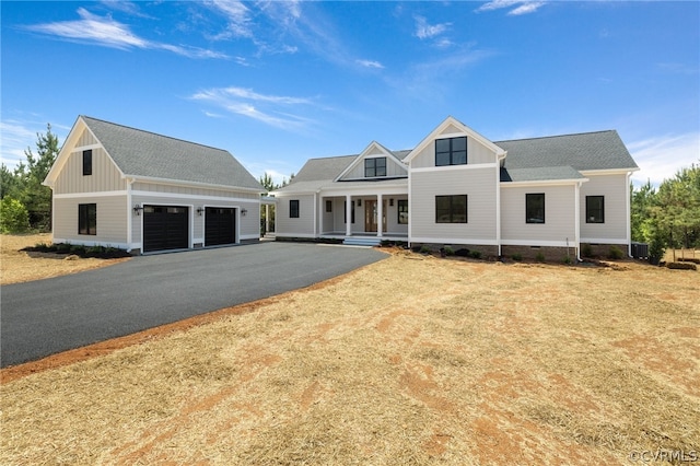 modern farmhouse featuring a garage and covered porch