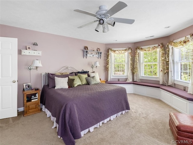 bedroom featuring ceiling fan and light colored carpet