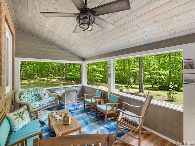 sunroom / solarium with wooden ceiling, ceiling fan, and vaulted ceiling