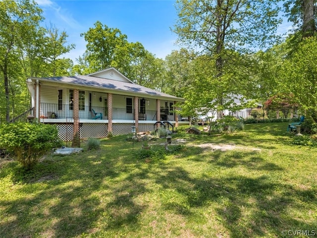 back of house with covered porch and a yard