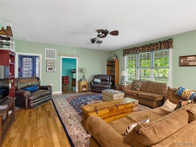 living room with ceiling fan and light hardwood / wood-style floors