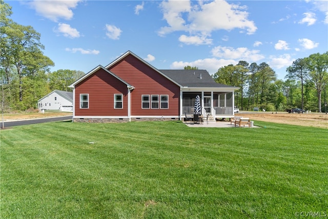 rear view of house featuring a patio and a yard