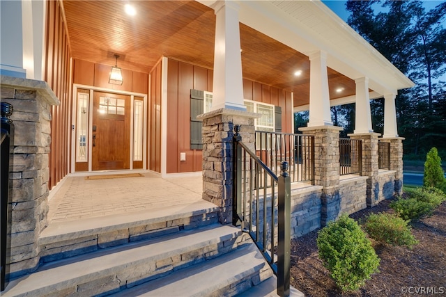 view of exterior entry featuring a porch