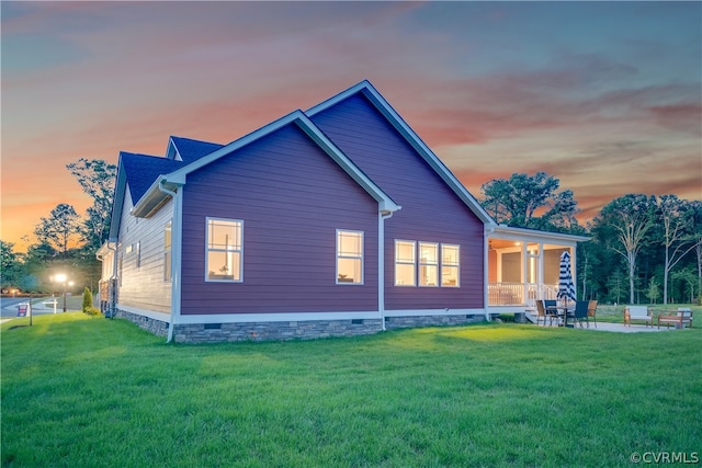 back house at dusk with a yard