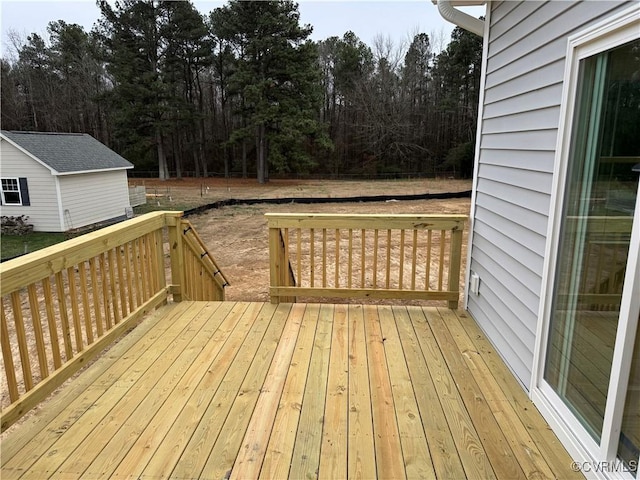 wooden terrace featuring an outbuilding