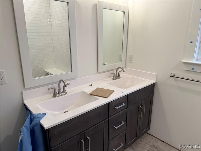 full bathroom with double vanity and a sink