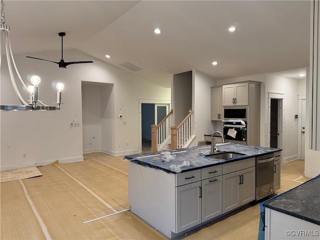 kitchen with visible vents, lofted ceiling, appliances with stainless steel finishes, gray cabinets, and a sink