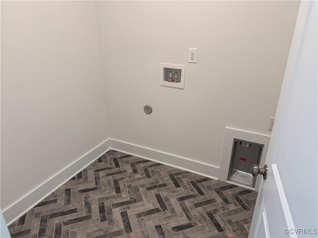 laundry area with laundry area, hookup for a washing machine, and baseboards