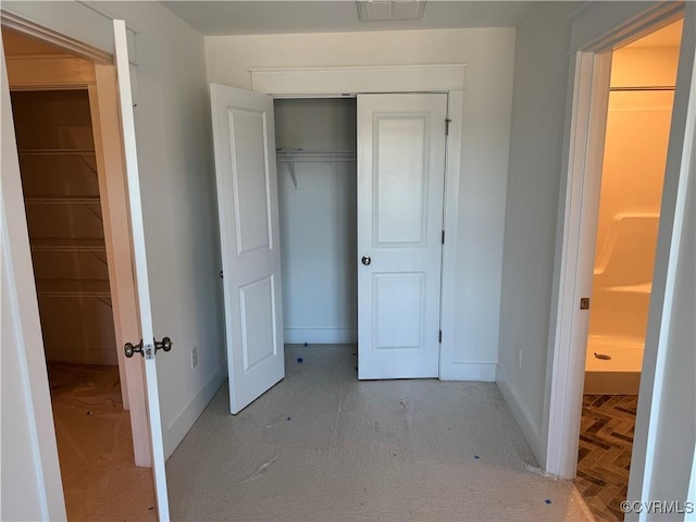 unfurnished bedroom featuring a closet, visible vents, and baseboards