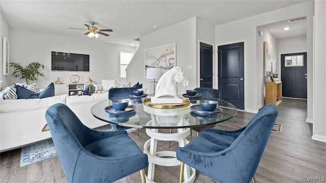 dining area with hardwood / wood-style floors and ceiling fan